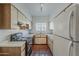 Galley kitchen features white cabinets, tile floors and plenty of room for appliances at 1935 W Morten Ave # 17, Phoenix, AZ 85021