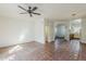 Large living area with tile floors, ceiling fan, and adjacent kitchen area at 1935 W Morten Ave # 17, Phoenix, AZ 85021