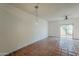 Spacious living area featuring tile floors, a ceiling fan, and sliding glass doors at 1935 W Morten Ave # 17, Phoenix, AZ 85021
