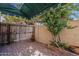 Private outdoor patio with brick flooring, wooden fence, potted flowers, and a shade canopy at 1935 W Morten Ave # 17, Phoenix, AZ 85021