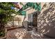Cozy outdoor patio space with brick flooring, a sliding glass door, and flowering bushes at 1935 W Morten Ave # 17, Phoenix, AZ 85021