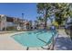 Bright community pool with clear blue water surrounded by fence and manicured green landscaping at 1935 W Morten Ave # 17, Phoenix, AZ 85021