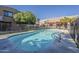 Community pool surrounded by manicured landscaping and apartment buildings at 1935 W Morten Ave # 17, Phoenix, AZ 85021