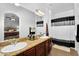 Well-lit bathroom with a double sink vanity and a shower-tub combination at 1950 N Center St # 101, Mesa, AZ 85201