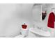 Modern powder room showcasing elegant fixtures, round mirror, and red decor accents at 1950 N Center St # 101, Mesa, AZ 85201
