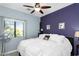 Comfortable bedroom with a large window and a contrasting accent wall at 1950 N Center St # 101, Mesa, AZ 85201