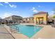 Outdoor pool with a shaded gazebo, lounging spots, and attractive community buildings at 1950 N Center St # 101, Mesa, AZ 85201