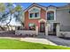 Two-story townhome with desert landscaping and stucco exterior. Front patio with gate at 1950 N Center St # 101, Mesa, AZ 85201