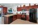 Modern kitchen featuring dark wood cabinetry and black appliances at 1950 N Center St # 101, Mesa, AZ 85201