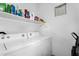 Functional laundry room with washer, dryer, storage shelf, and efficient use of space at 1950 N Center St # 101, Mesa, AZ 85201