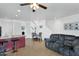 Open concept living room features tile flooring and a cozy gray sofa at 1950 N Center St # 101, Mesa, AZ 85201