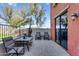 Relaxing outdoor patio with tile flooring, seating, and view of mature trees at 1950 N Center St # 101, Mesa, AZ 85201