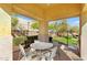 Covered patio area with a round table and seating, perfect for relaxing or entertaining guests outdoors at 1950 N Center St # 101, Mesa, AZ 85201