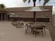 Inviting poolside area with lounge chairs and tables with umbrellas for relaxing at 20327 N 110Th Dr, Sun City, AZ 85373