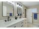 Bathroom featuring dual sinks, black hardware, and modern fixtures at 20802 N 74Th Ln, Glendale, AZ 85308