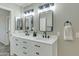 Well-lit bathroom with dual sinks, quartz countertop and modern fixtures at 20802 N 74Th Ln, Glendale, AZ 85308