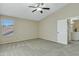 Spacious bedroom with carpet, vaulted ceilings, a ceiling fan, and a doorway to another room at 20802 N 74Th Ln, Glendale, AZ 85308