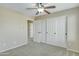 Bedroom with carpet, closet, ceiling fan, and natural light at 20802 N 74Th Ln, Glendale, AZ 85308