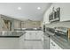 Updated kitchen featuring white cabinets, stylish dark countertops, an island and stainless appliances at 20802 N 74Th Ln, Glendale, AZ 85308