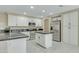 Updated kitchen featuring white cabinets, stylish dark countertops, an island and stainless appliances at 20802 N 74Th Ln, Glendale, AZ 85308