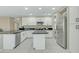 Updated kitchen featuring white cabinets, stylish dark countertops, an island and stainless appliances at 20802 N 74Th Ln, Glendale, AZ 85308