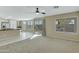 Bright living room featuring an open layout, ceiling fan, sliding glass door to yard, and backyard views at 20802 N 74Th Ln, Glendale, AZ 85308
