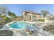 Backyard featuring a sparkling pool with diving board and partial view of the two-story home at 20802 N 74Th Ln, Glendale, AZ 85308