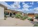 Spacious backyard featuring neutral ground cover, patio, garden beds and wooden shed at 20961 E Stacey Rd, Queen Creek, AZ 85142