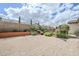 Spacious backyard featuring neutral ground cover, lush plantings and mature shade trees at 20961 E Stacey Rd, Queen Creek, AZ 85142