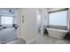 Serene bathroom with a standalone tub, tile accents, and soft natural light at 20961 E Stacey Rd, Queen Creek, AZ 85142