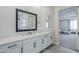 Elegant bathroom featuring white cabinets, a large mirror, and sleek countertops at 20961 E Stacey Rd, Queen Creek, AZ 85142