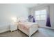 Bright bedroom featuring a large window, white furniture, and calming decor at 20961 E Stacey Rd, Queen Creek, AZ 85142