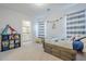 Bright bedroom featuring a cozy bed, dinosaur decor, and direct access to the bathroom at 20961 E Stacey Rd, Queen Creek, AZ 85142