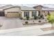 Charming single-story home featuring desert landscaping, stone accents, and a paver driveway leading to a two-car garage at 20961 E Stacey Rd, Queen Creek, AZ 85142