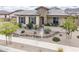 Inviting single-level home with desert landscaping and stone facade, complemented by a cozy front porch at 20961 E Stacey Rd, Queen Creek, AZ 85142
