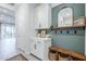 Hallway with white cabinets, a mirror, a wood shelf and coat hooks at 20961 E Stacey Rd, Queen Creek, AZ 85142