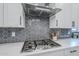 Updated kitchen featuring gas cooktop with modern vent hood and stylish backsplash at 20961 E Stacey Rd, Queen Creek, AZ 85142