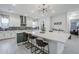 Contemporary kitchen with a large island, modern lighting, white cabinetry, and sleek countertops at 20961 E Stacey Rd, Queen Creek, AZ 85142