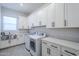 Spacious laundry room with abundant cabinets, quartz countertops and stainless steel sink at 20961 E Stacey Rd, Queen Creek, AZ 85142