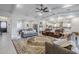 Open-concept living space with ample seating, tray ceilings, tile flooring, and seamless flow to the kitchen at 20961 E Stacey Rd, Queen Creek, AZ 85142