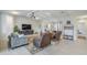 Living room featuring comfortable seating, an entertainment center, and an open layout to the dining area and kitchen at 20961 E Stacey Rd, Queen Creek, AZ 85142