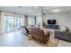 Bright living room featuring an entertainment center, comfortable seating, and sliding glass doors leading to the outside at 20961 E Stacey Rd, Queen Creek, AZ 85142