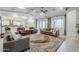 Bright and airy living room with tray ceilings, modern furniture, large windows, and a patterned area rug at 20961 E Stacey Rd, Queen Creek, AZ 85142