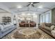 Spacious living room with tray ceilings, comfortable seating, and an open floor plan leading to the modern kitchen at 20961 E Stacey Rd, Queen Creek, AZ 85142