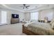 Open main bedroom boasts a cozy sitting area, tray ceiling, and natural light at 20961 E Stacey Rd, Queen Creek, AZ 85142