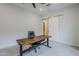 Home office with a standing desk, a ceiling fan and sliding barn doors at 20961 E Stacey Rd, Queen Creek, AZ 85142