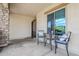 Cozy covered patio with stone column accents, features a charming wrought-iron gate and an outdoor seating area at 20961 E Stacey Rd, Queen Creek, AZ 85142