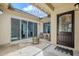 Charming covered patio with string lights, showcases sliding glass doors, comfortable seating, and a barrel planter at 20961 E Stacey Rd, Queen Creek, AZ 85142