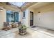 Inviting covered patio with stylish string lights, offering comfortable seating and a charming barrel planter at 20961 E Stacey Rd, Queen Creek, AZ 85142