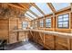 Interior view of the garden shed, featuring natural light and wood shelving at 20961 E Stacey Rd, Queen Creek, AZ 85142